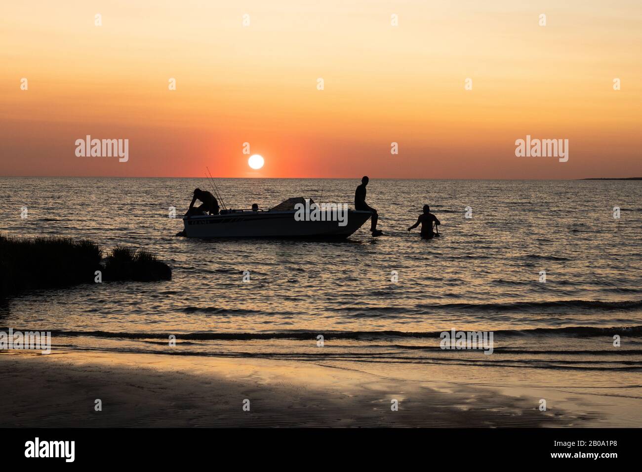 Menschen, die während des Sonnenuntergangs in Uruguay von einem Boot abkommen Stockfoto