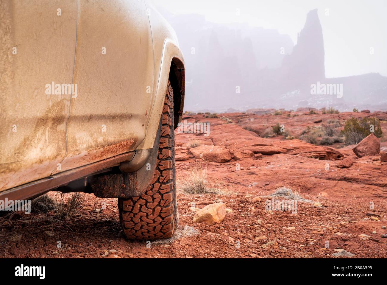 Geländewagen oder LKW mit Geländewagen und Geländewagen, die im Winter auf einem Trail fahren - Fisher Towers in Moab-Gebiet, Utah, Geländefahrten, Freizeit- und Reisekonzept Stockfoto