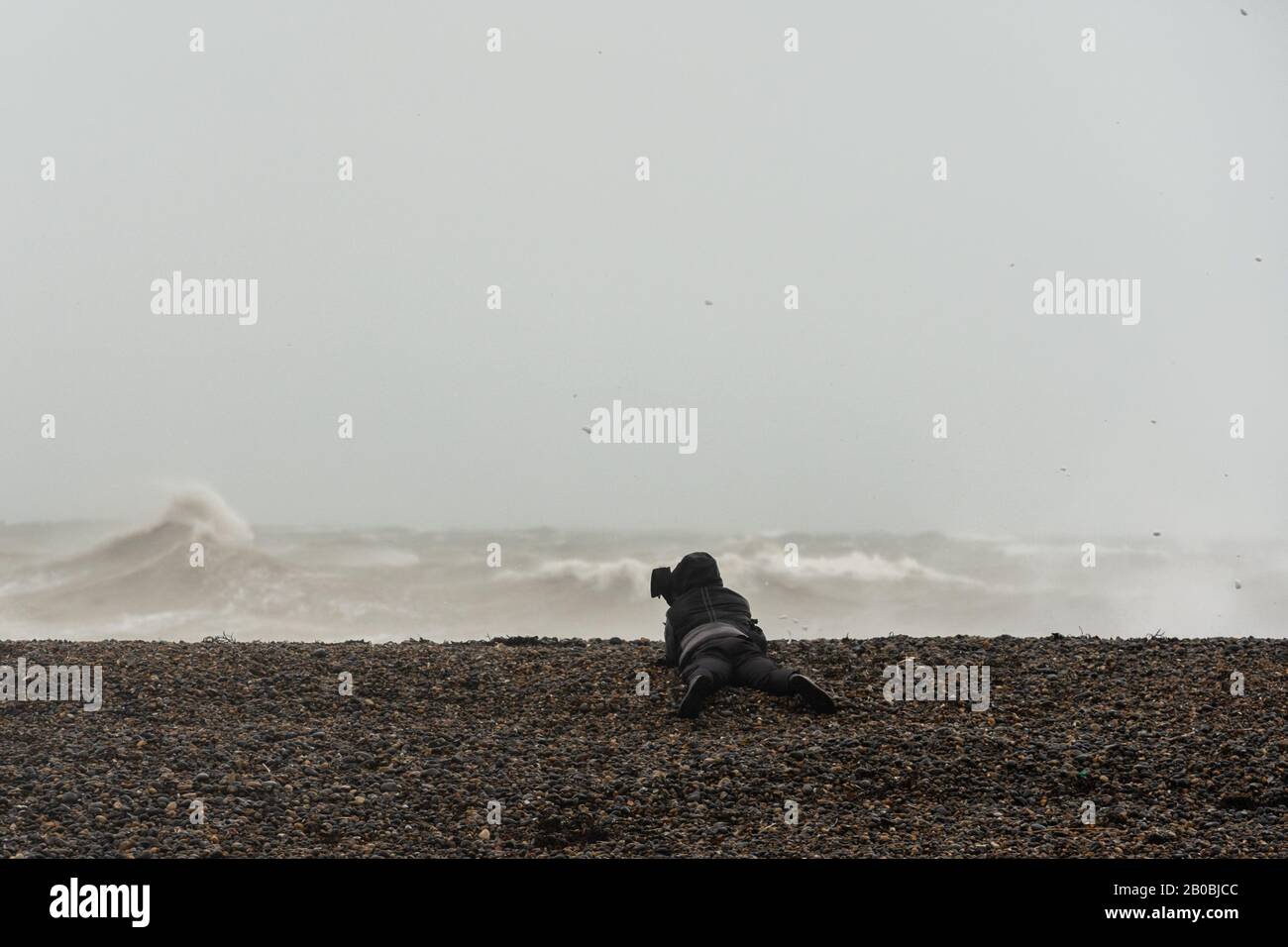 Ein Fotograf, der sich beim Sturm Ciara am 9. Februar 2020 vor der Küste von Sussex bei Newhaven fotografiert Stockfoto