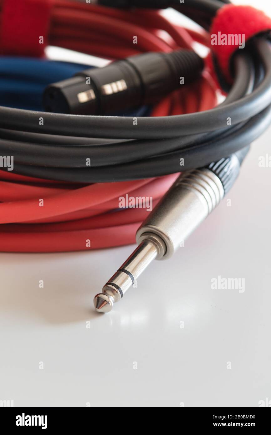 Audiokabel mit silberfarbenem TRS-Klinkenanschluss und XLR-Anschluss auf weißem Hintergrund. Musik, Audio, Hi-Fi, Konnektivität und Tonwiedergabe. Stockfoto