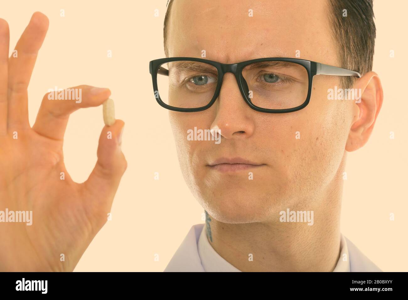 Nahaufnahme von jungen gutaussehenden Mann Arzt vitamin Tablette suchen Stockfoto