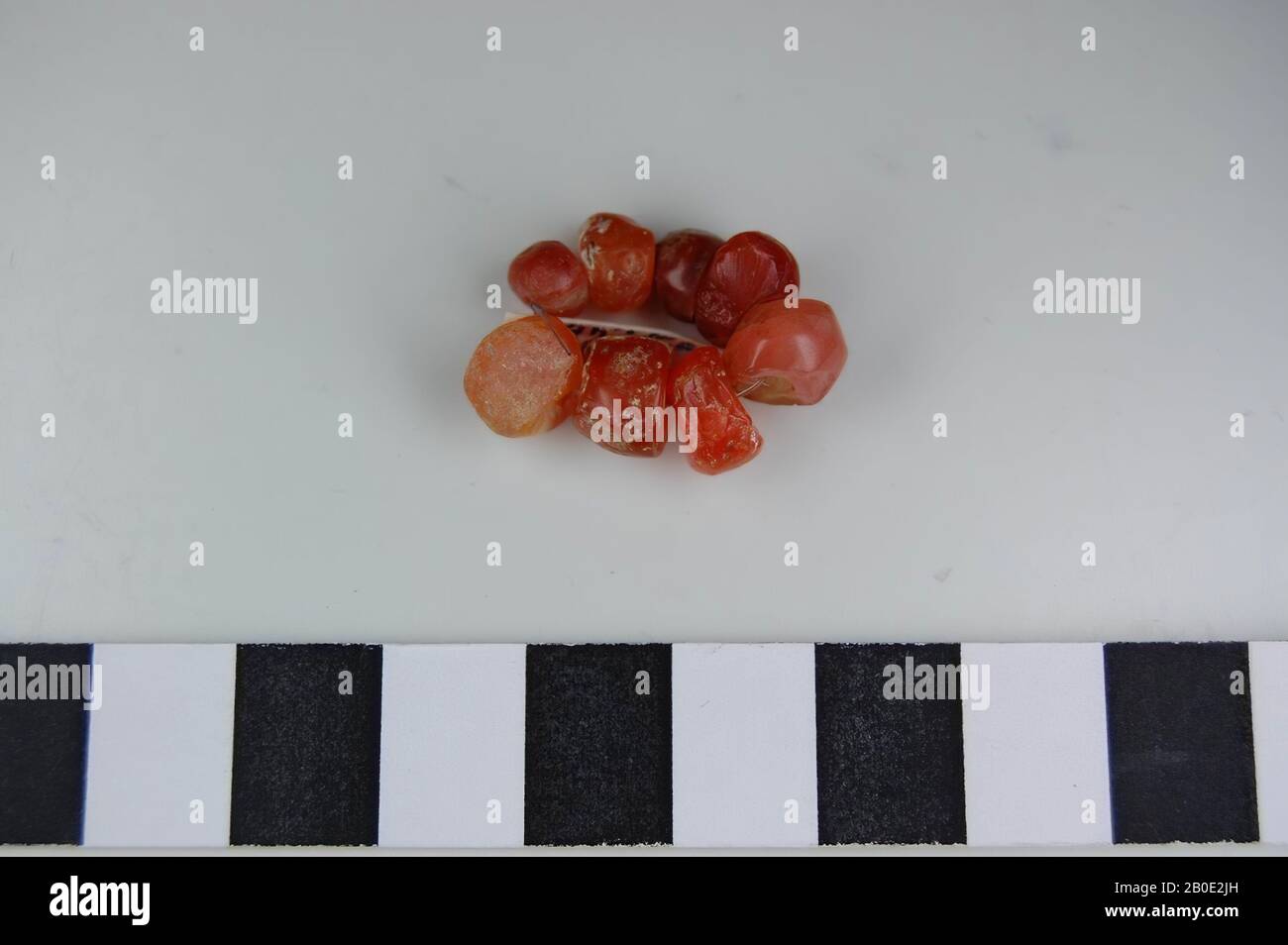 Eine Kette aus 8 runden Perlen mit abgeflachten Seiten von Orange Stockfoto