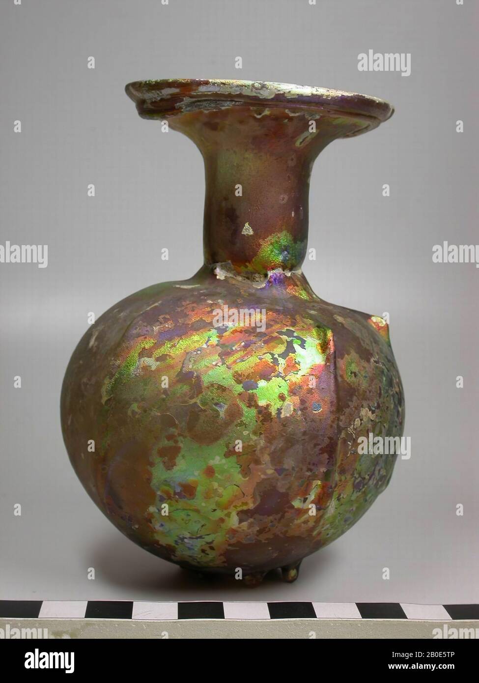 Kugelflasche mit zylindrischem Hals und trichterförmigem Mund aus hellviolettem Glas. Auf der Schulter und am Bauch gequetschte Rippen. Als Standring ein Kreis kleiner zusammengedrückter Nuppen. Um den Inhalt einer Vase aus der Öffnung Tropfen zu lassen, wurden in der Antike Tropfen "betet Vasen" hergestellt. Der Hals dieser Vasen wird innen von einer Scheibe verschlossen, die in der Mitte eine kleine Öffnung hat. Wenn die Flasche umgedreht wird, kommt das Parfüm (oder duftendes Öl) in Tropfen heraus., Geschirr, Glas, H 12 cm, Syrien Stockfoto
