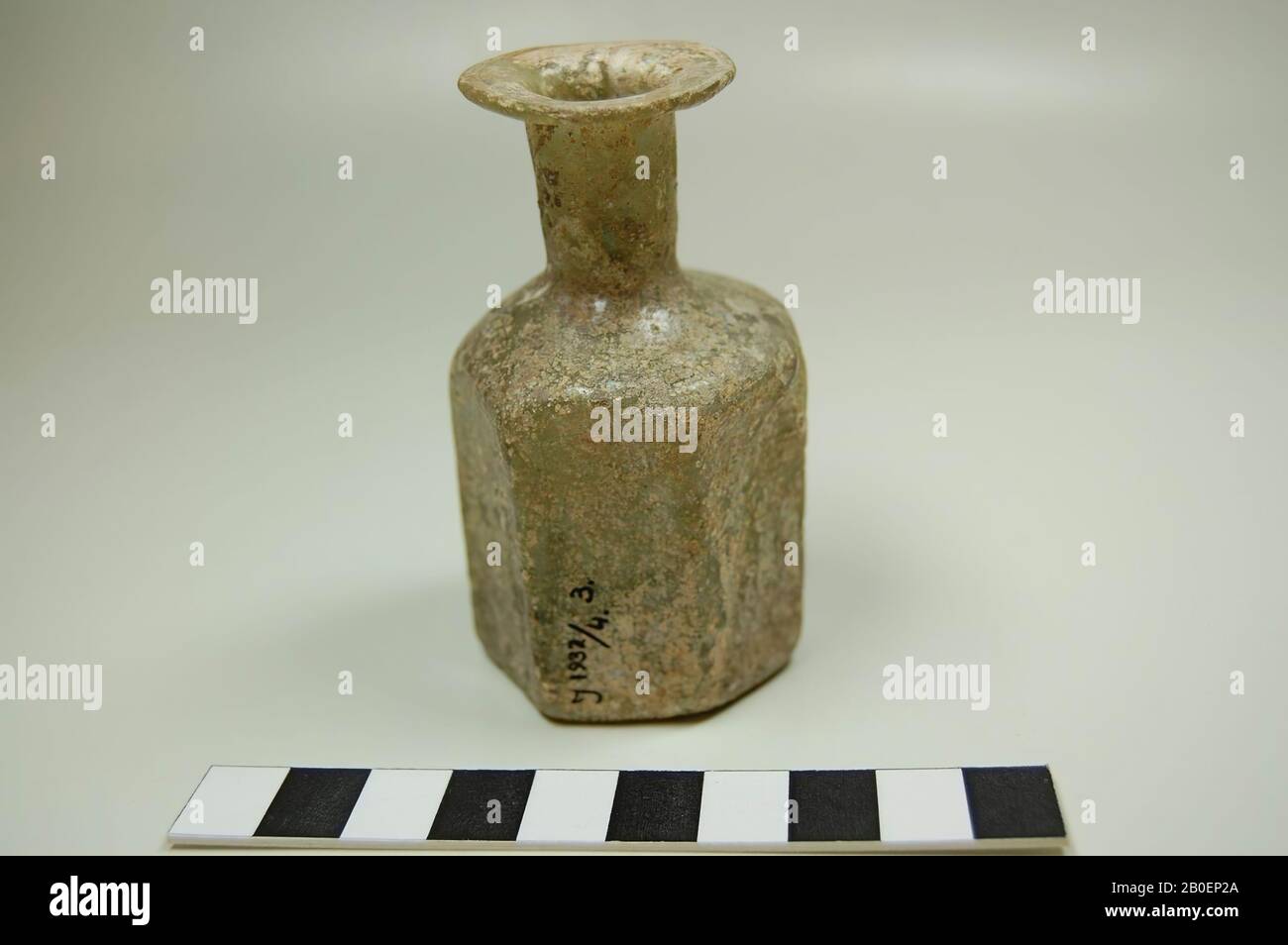 Flasche blassgrünes Glas mit graubrauner Iridescenz. Siebenseitiger Körper, zylindrischer Hals mit flachem Mundstück, Flasche, Glas, 8 cm Stockfoto