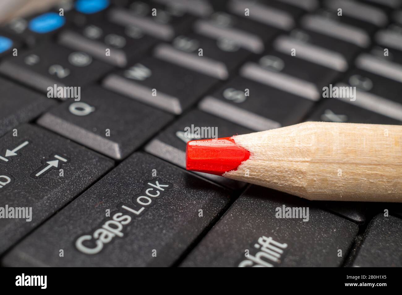Roter Bleistift auf einer Computertastatur, Nahansicht Stockfoto