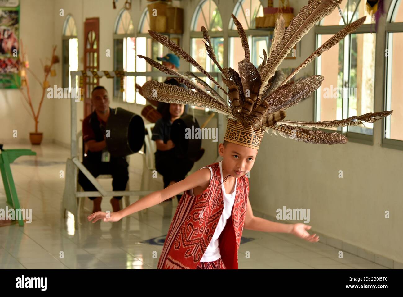 Der Junge präsentiert einen traditionellen Iban-Tanz, der für die indigene Bevölkerung der Gegend von Ulu Temburong, Brunei, typisch ist Stockfoto