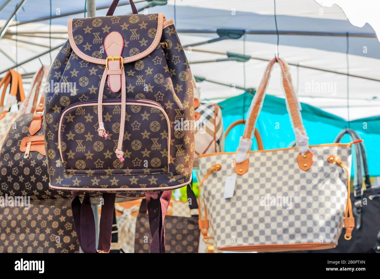Fake High-End-Modemarke berühmte Designer-Handtaschen und Rucksäcke zum Verkauf auf einem lokalen Flohmarkt im Freien in Ventimiglia, Italien Stockfoto