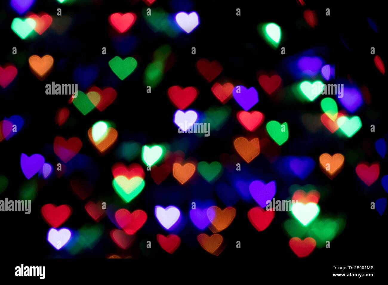 Farbenfroher Herzbokeh-Hintergrund. Hintergrund für den Valentinstag Stockfoto