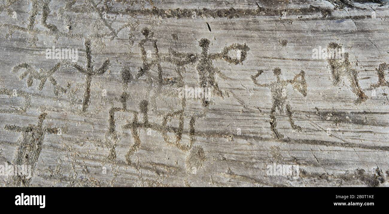 Petroglyph, Felsschnitzerei, einer Gruppe von Kriegern, die Schwerter und Schillinge tragen. Von den alten Camuni-Leuten in der Eisenzeit zwischen 1000-1600 v. Chr. geschnitzt Stockfoto
