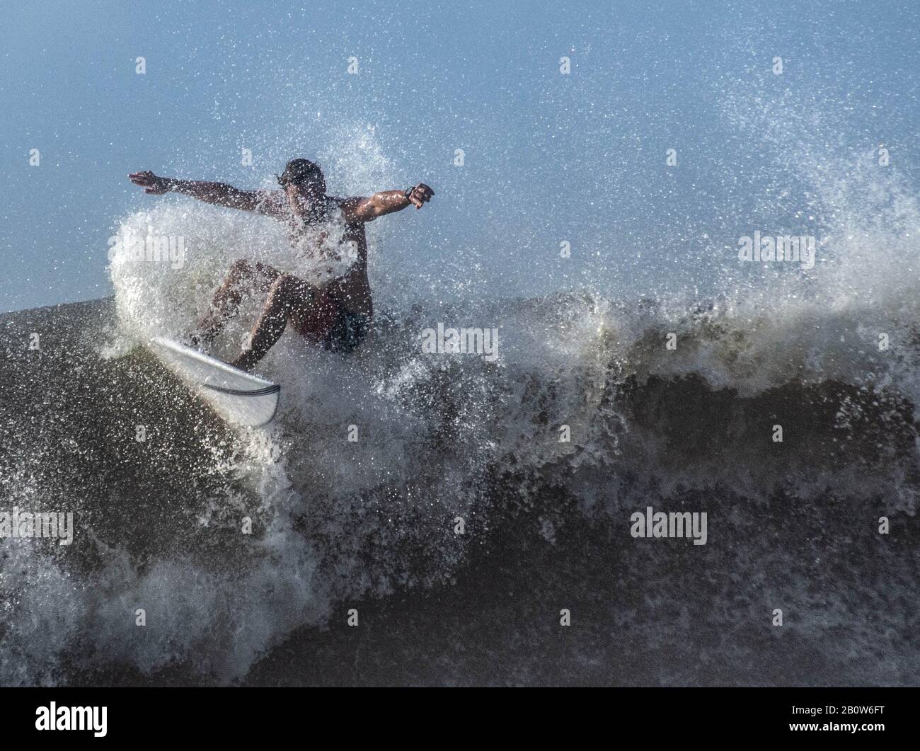 Ein Surfer reitet große Wellen, die vom tropischen Sturm Dorian angestoßen wurden, während der Sturm sich Charleston South Carolina nähert. Stockfoto