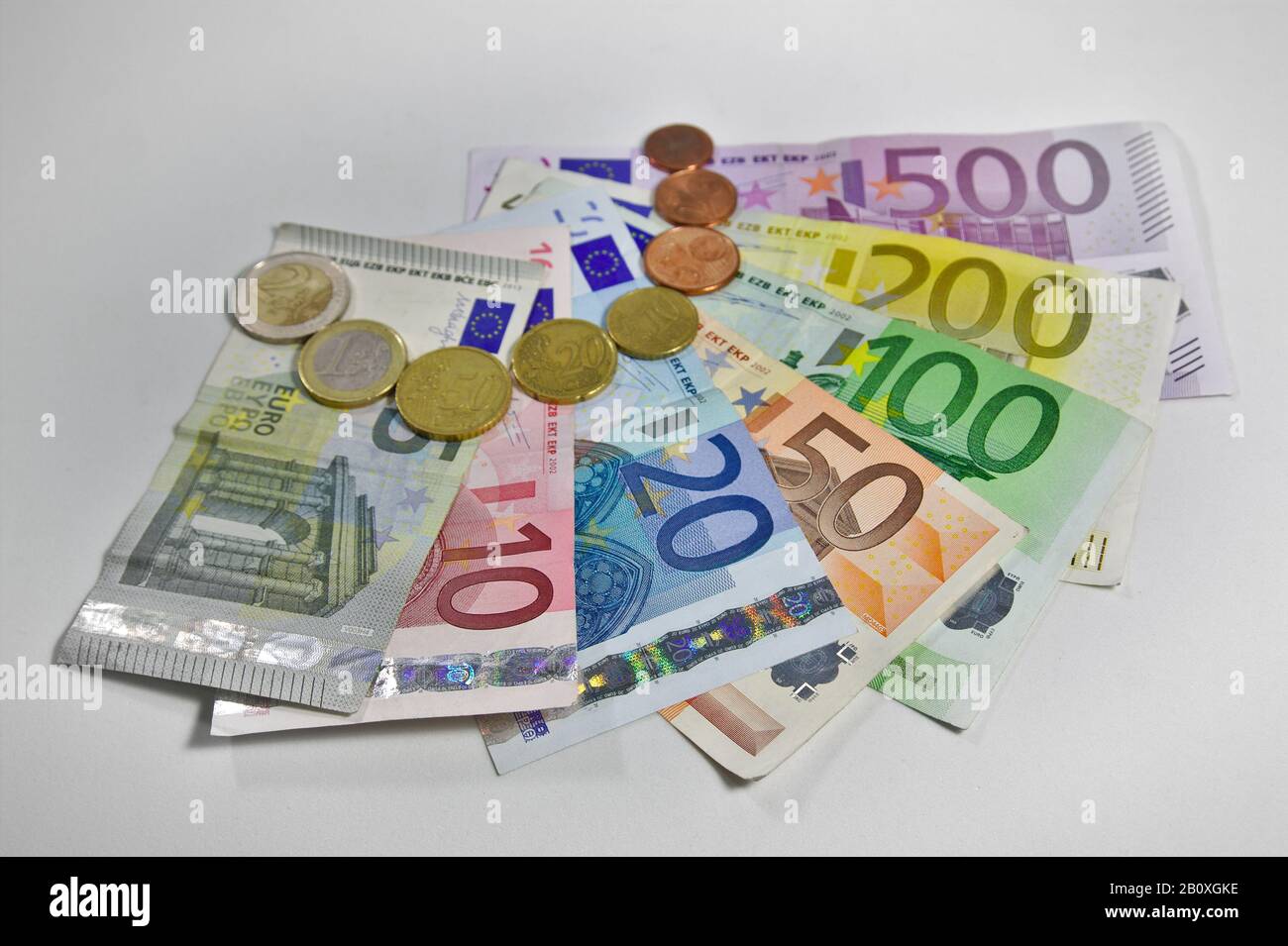 Blick von oben auf einige Euro-Münzen und -Rechnungen von 5 bis 500 Euro, die auf einem Tisch liegen Stockfoto