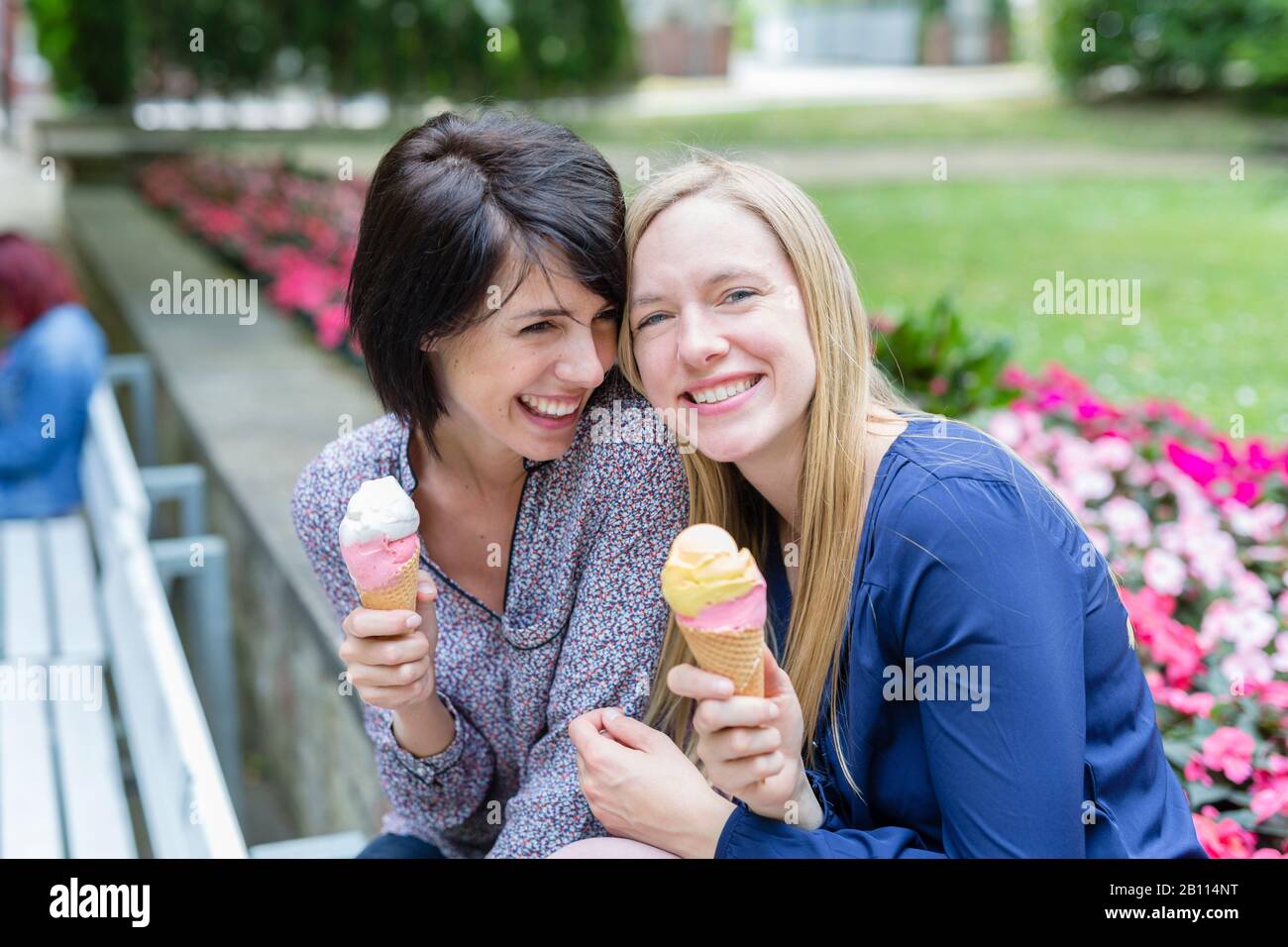Zwei Freunde lachen zusammen und essen Eis Stockfoto