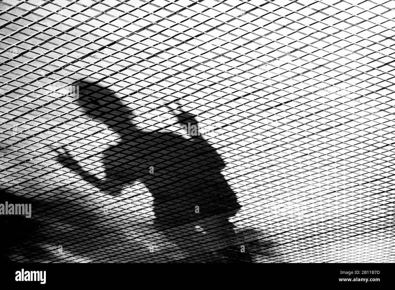 Verschwommene Schatten-Silhouette eines jungen Mannes mit V-Fingerzeichen Stockfoto