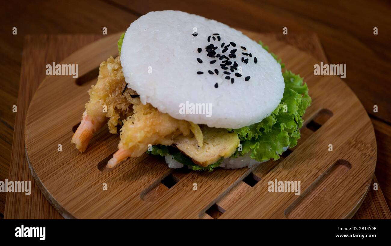 Japanisches Lebensmittelkonzept. Hausgemachter Sushi-Reisburger mit Garnelen Tempura, Gemüse und Tamagoyaki Stockfoto
