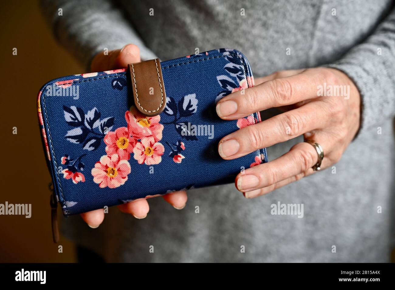 Nahaufnahme einer älteren Frau, die ihre Geldbörse hält. Stockfoto