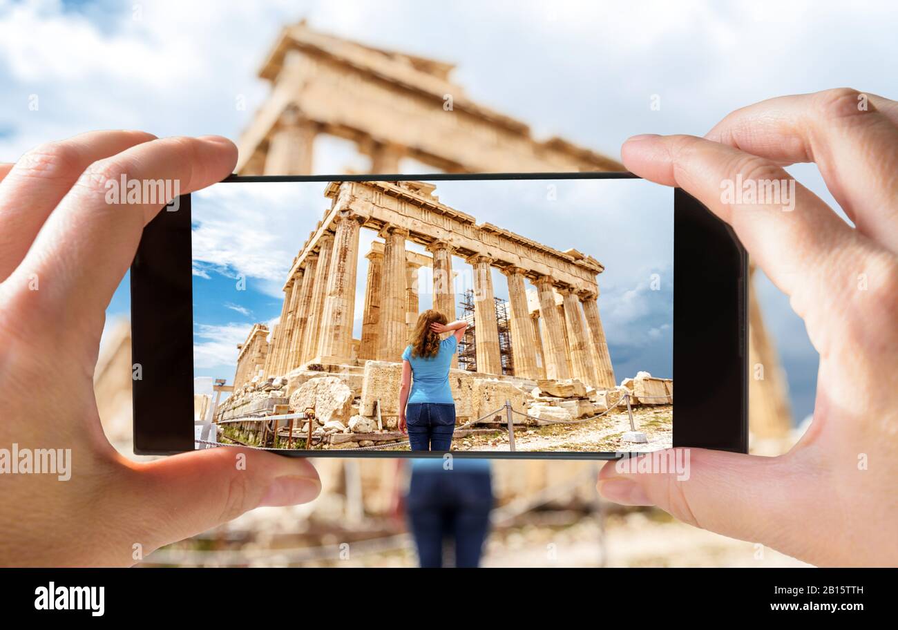 Tourist fotografiert junge Frau in Athen per Handy, Griechenland. Dieser Ort ist ein Wahrzeichen Athens. Bild des Altgriechischen Parthenon auf Stockfoto