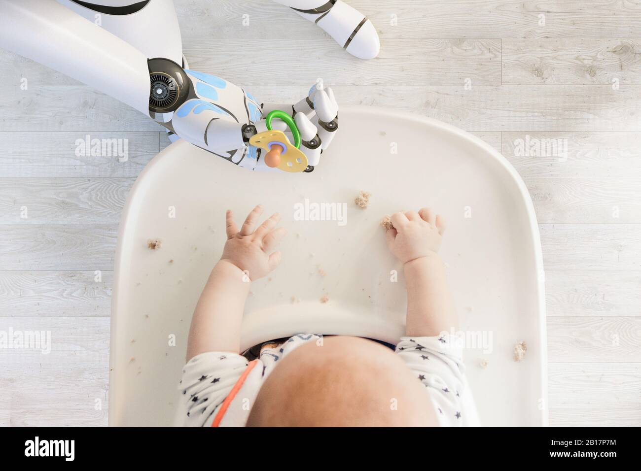Roboterhand, die dem kleinen Jungen, der im Hochstuhl sitzt, einen Schnuller gibt, der mit Brotkrümeln spielt, Draufsicht Stockfoto