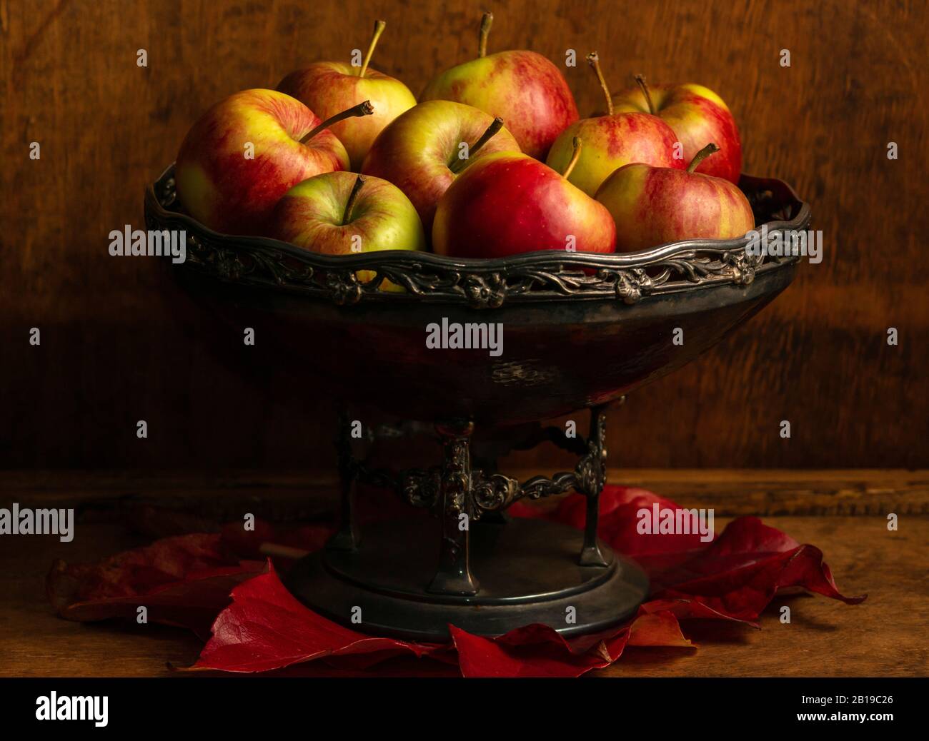 Äpfel im Vintage-Korb aus Metall als Stillleben-Komposition Stockfoto