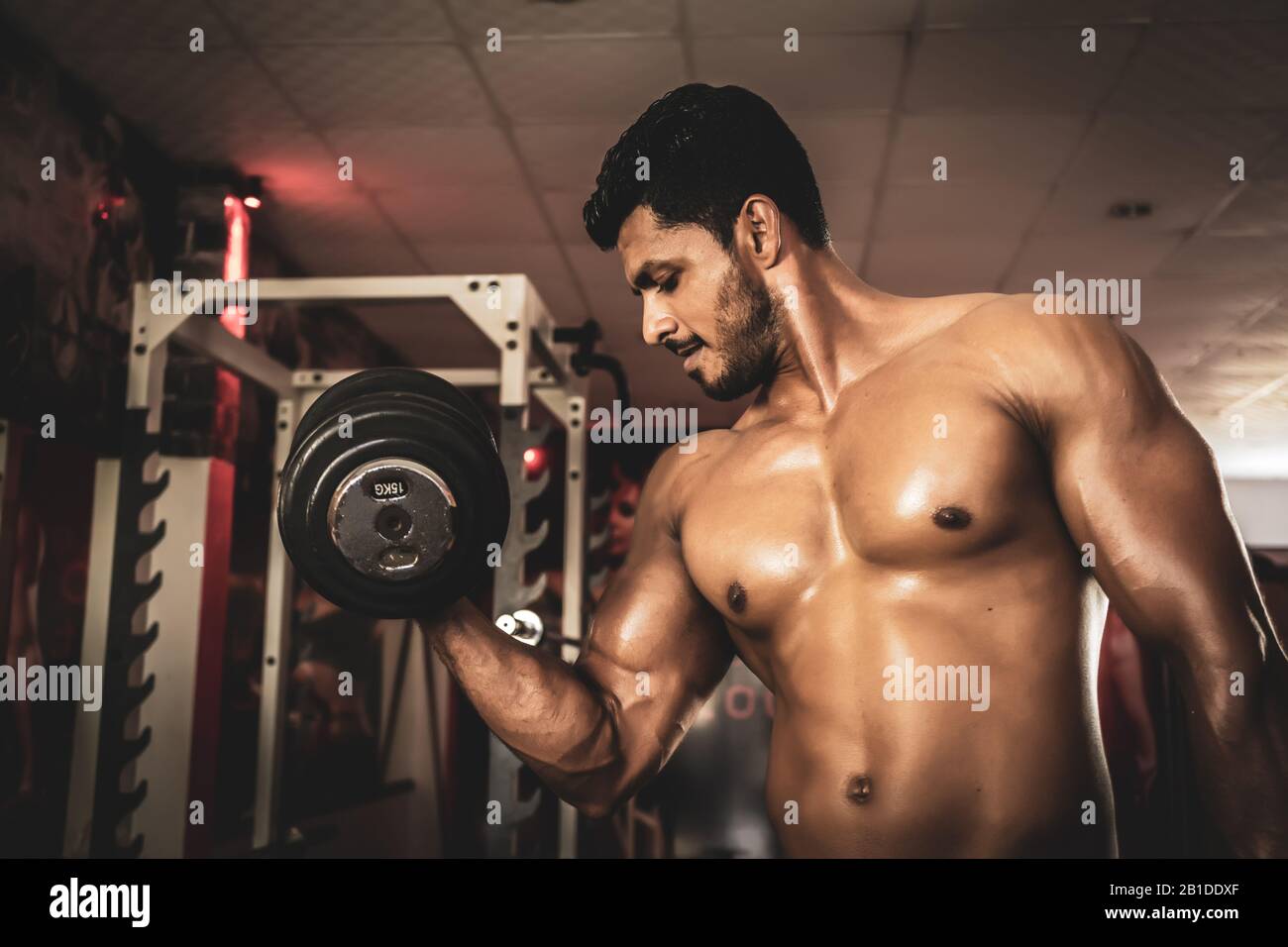 Junger Mann, Der Biceps Dumbbell Concentration Curls Ausarbeitet Stockfoto