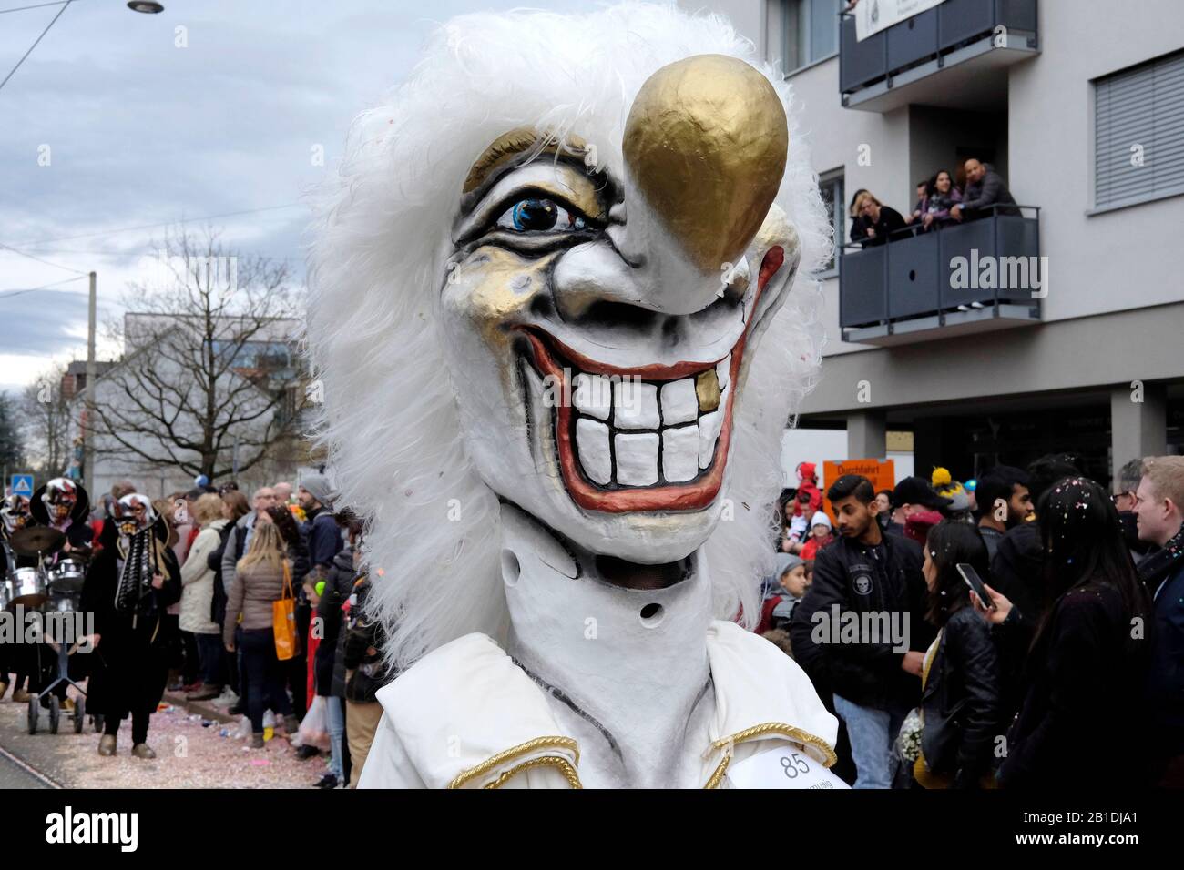 Ein Teilnehmer, der beim Karneval in Allschwil, Basel landschaft, Schweiz eine Maske trägt Stockfoto