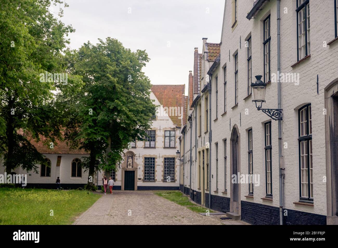 Der Beginenhof von Brüggen ist ein ruhiger Ort im Stadtzentrum von Brüggen. Weiß gestrichene Häuser stehen entlang einer Straße mit Kopfsteinpflaster. Stockfoto