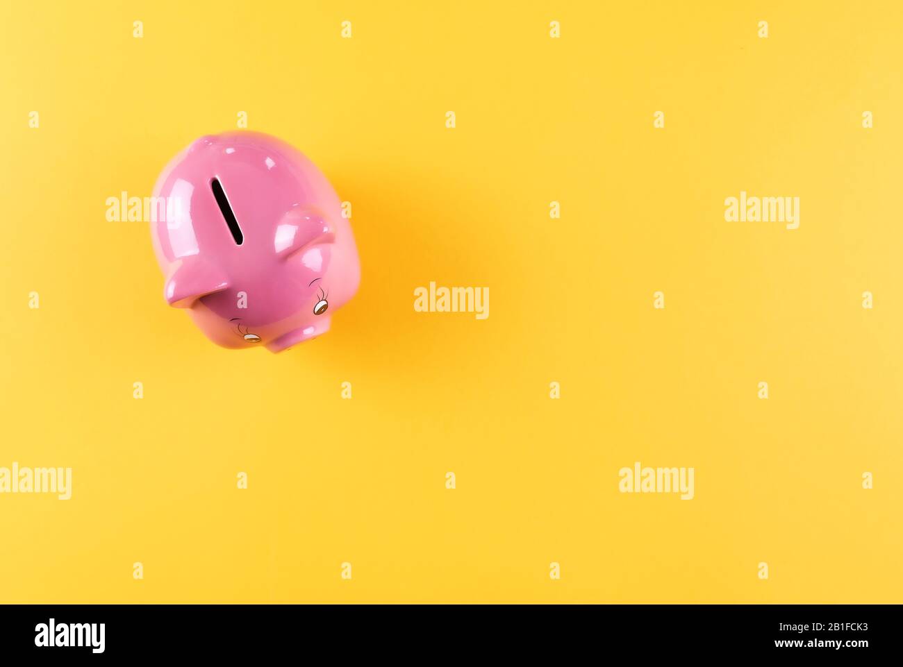 Draufsicht auf die rosafarbene Schweinebank mit leuchtendem orangefarbenem Hintergrund, Sparkonzept und Anlagekonzept Stockfoto