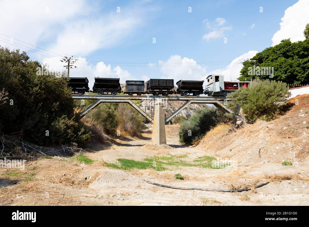 Alter Bergbauzug und Lastwagen auf einer Brücke über ein trockenes Flussbett bei Kalavasos Dorf. Zypern. Stockfoto