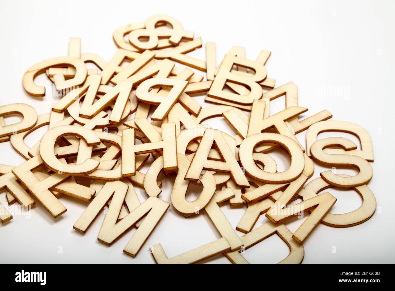 Buchstaben aus Holzalphabet, die das Wort Chaos auf weißem Hintergrund ausschreiben Stockfoto