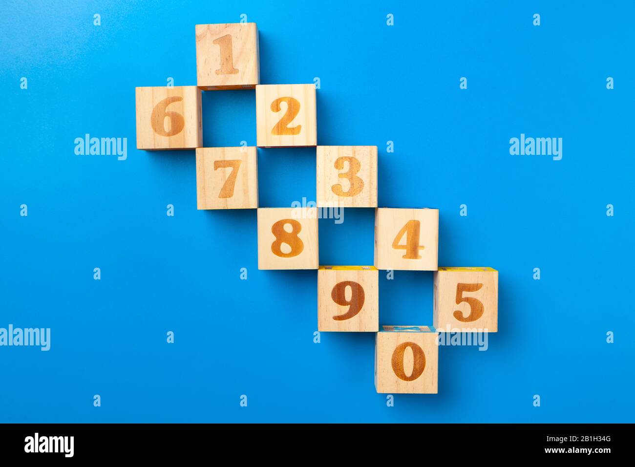 Zahlen. Bunte Holz-Alphabet-Blöcke auf blauem Hintergrund, flacher Lay, Draufsicht. Stockfoto