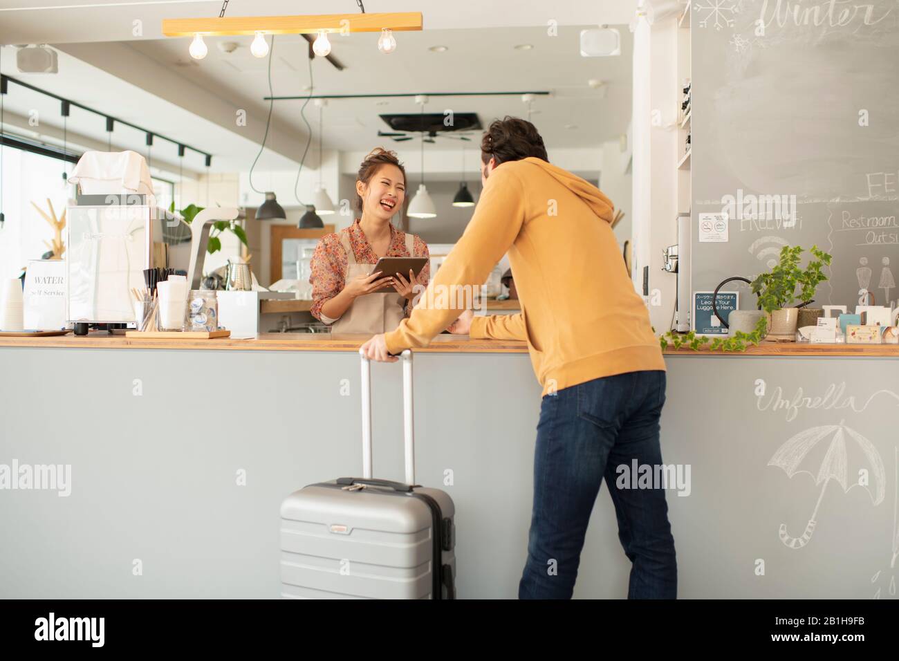 Junge Frau, die ausländische Touristen besucht Stockfoto