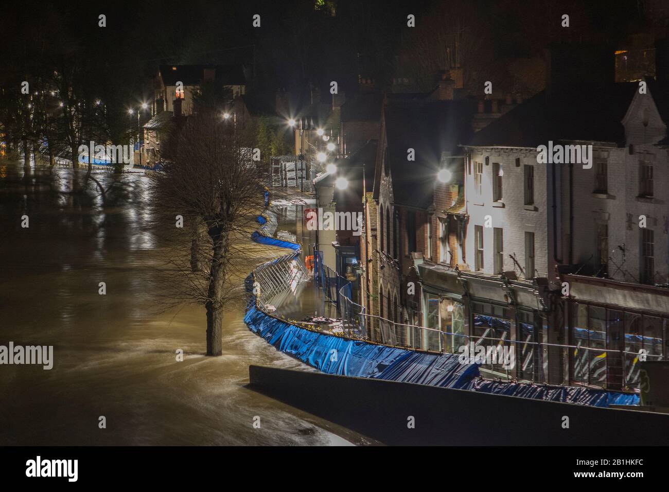 Ironbridge, Großbritannien. Februar 2020. 2-3 Uhr Ironbridge erlebte Rekordhochwasserpegel verursacht durch Sturm Dennis. Da der Wasserstand des Flusses Severn auf der Höhe der Hochwasserschutzanlagen prognostiziert wurde, hoffte man, dass Barrieren nicht durchbrochen werden. Um 3 Uhr morgens waren die Flußebenen nahe an der Spitze der Barrieren entlang des Wharfage, knickte Barrieren und seitliche Bewegungen konnten an Stellen in den Flutverteidigungen gesehen werden und Wasser war auf beiden Seiten des sichtbar, als Wasser unter den Verteidigungsanlagen sickerte. Die Evakuierung der Geschäfte und der Grundstücke blieb bestehen. Kredit: Paul Bunch/Alamy Live Nachrichten Stockfoto