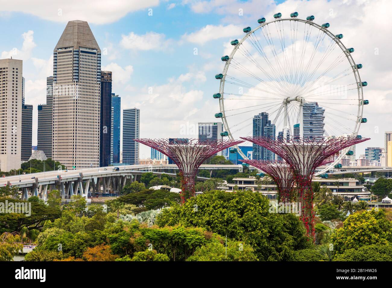 Blick auf die hoch aufragenden vertikalen Gärten und Superbäume in Gardens an der Bucht, Singapur, Asien gegen das Riesenrad, das Singapur-Flyer genannt wird Stockfoto
