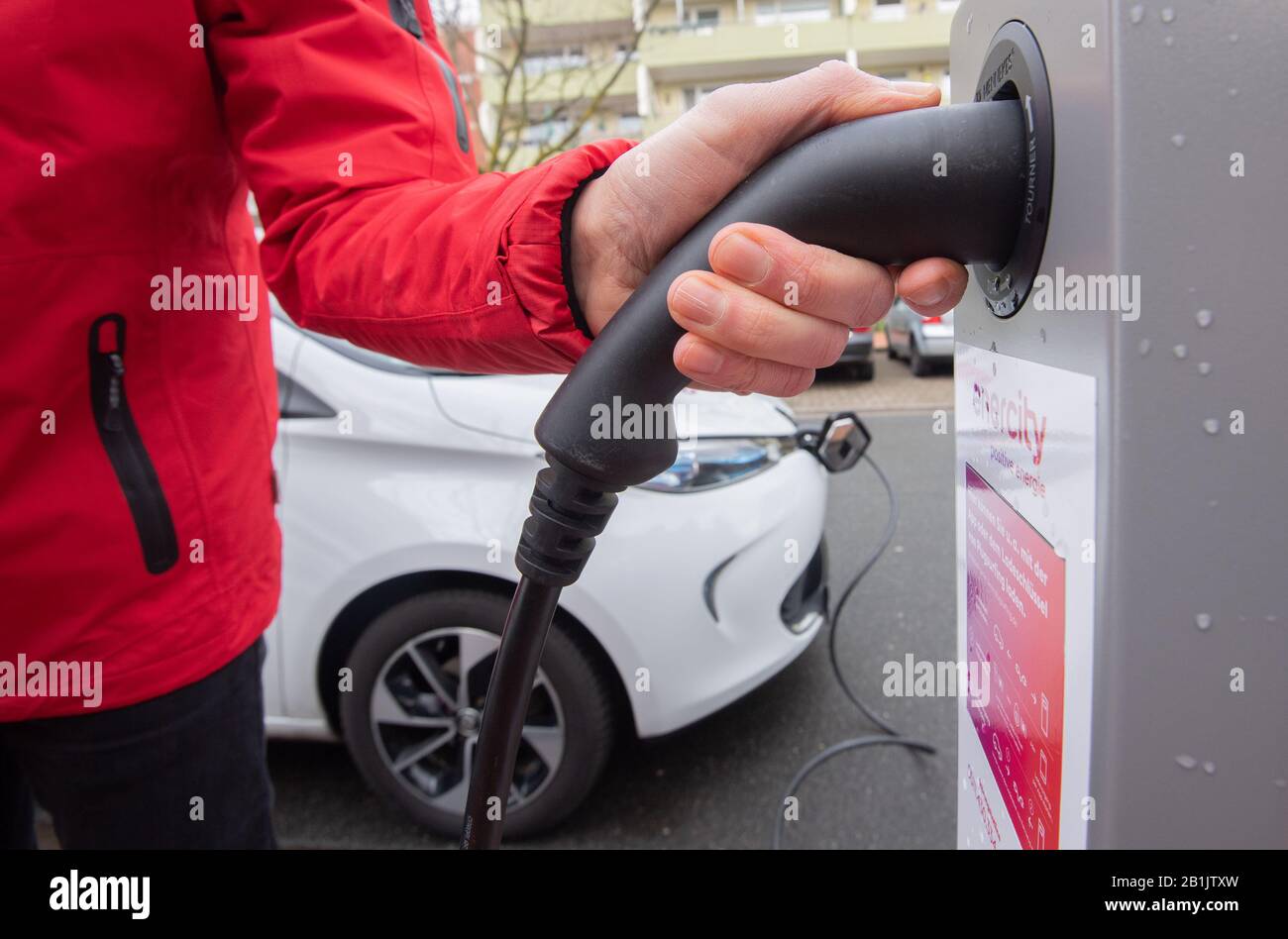 Langenhagen, Deutschland. Februar 2020. Jan Schröder aus Enercity verbindet ein Elektroauto von Renault mit einer neuen Ladestation, die in eine Straßenleuchte integriert wurde. Um die Ladeinfrastruktur für Elektroautos auszubauen, präsentieren der Energieversorger Enercity und die Stadt Langenhagen das Projekt einer Laternenladestation. Credit: Julian Stratenschulte / dpa / Alamy Live News Stockfoto