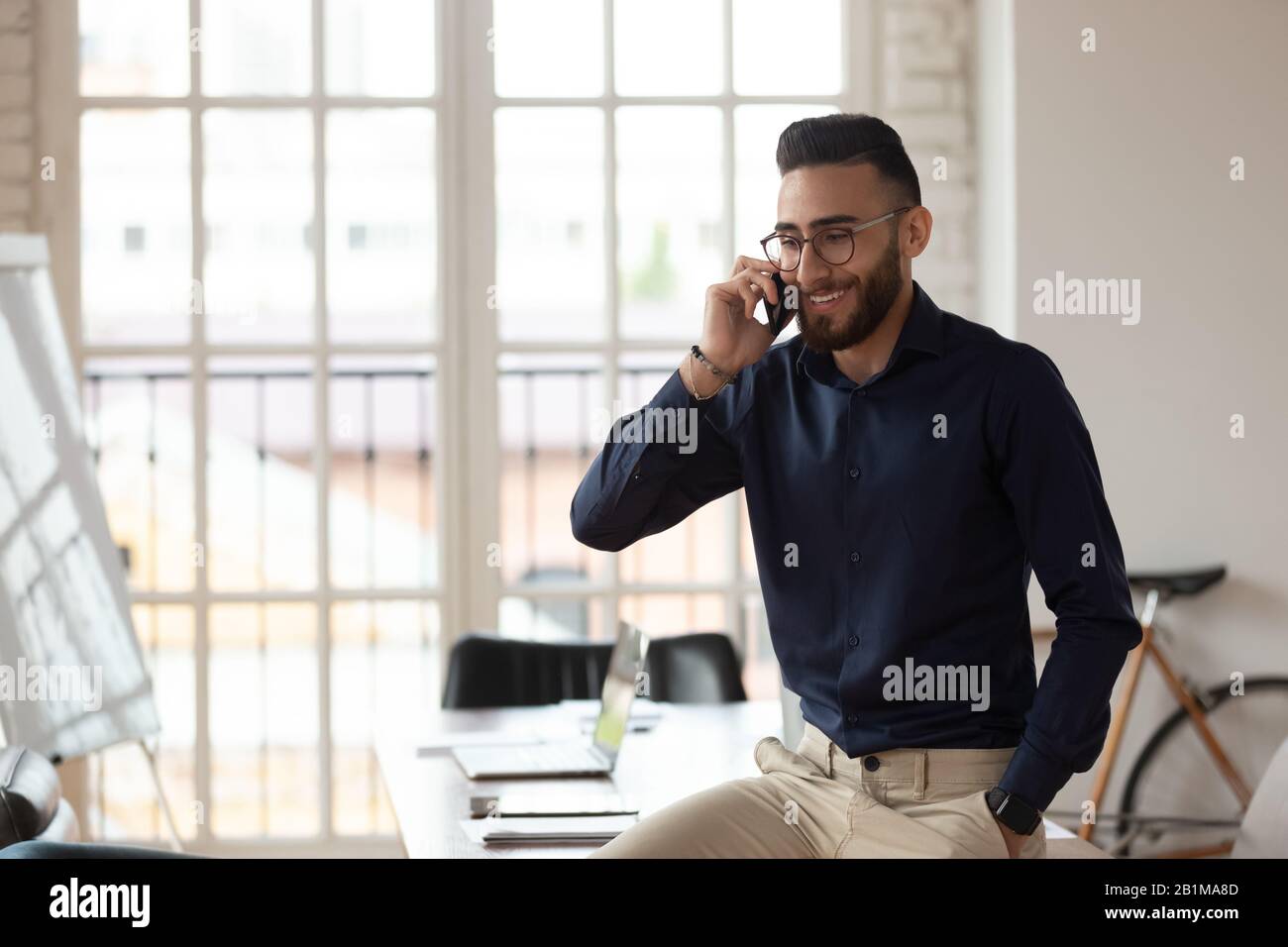 Mitarbeiter aus dem mittleren Osten innerhalb des Sitzungssaals telefonieren Stockfoto