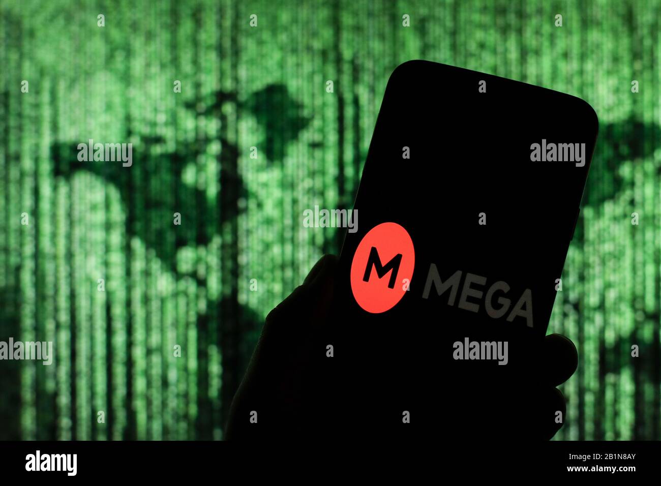 Mega-Upload-Logo des Cloud-Unternehmens wird auf dem Smartphone-Bildschirm mit einer Matrix-ähnlichen Weltkarte angezeigt, die im Hintergrund verschwommen zu sehen ist Stockfoto