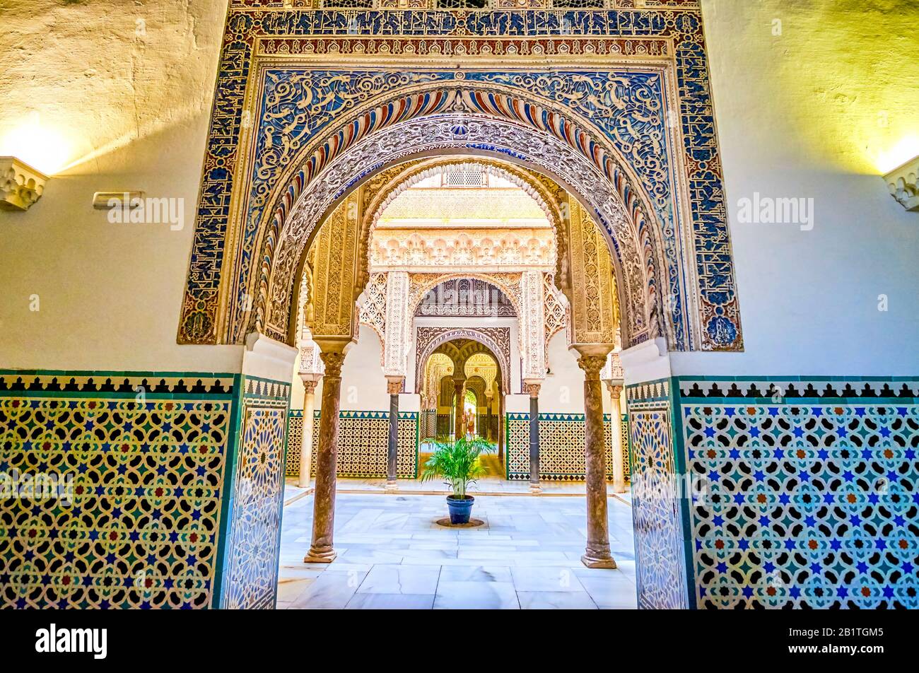 Sevilla, SPANIEN - 1. OKTOBER 2019: Der schön verzierte Bogenzugang zum mit farbenfrohem Putz verzierten Innenhof der Puppen auf October Stockfoto