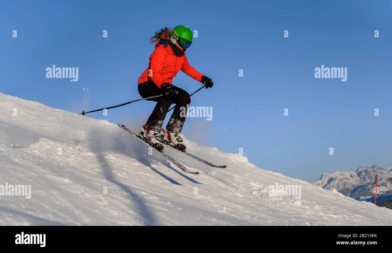 Skifahrer springt über Höcker, Steilabstieg, schwarze Piste, blauer Himmel, SkiWelt Wilder Kaiser, Brixen im Thale, Tyrol, Österreich Stockfoto