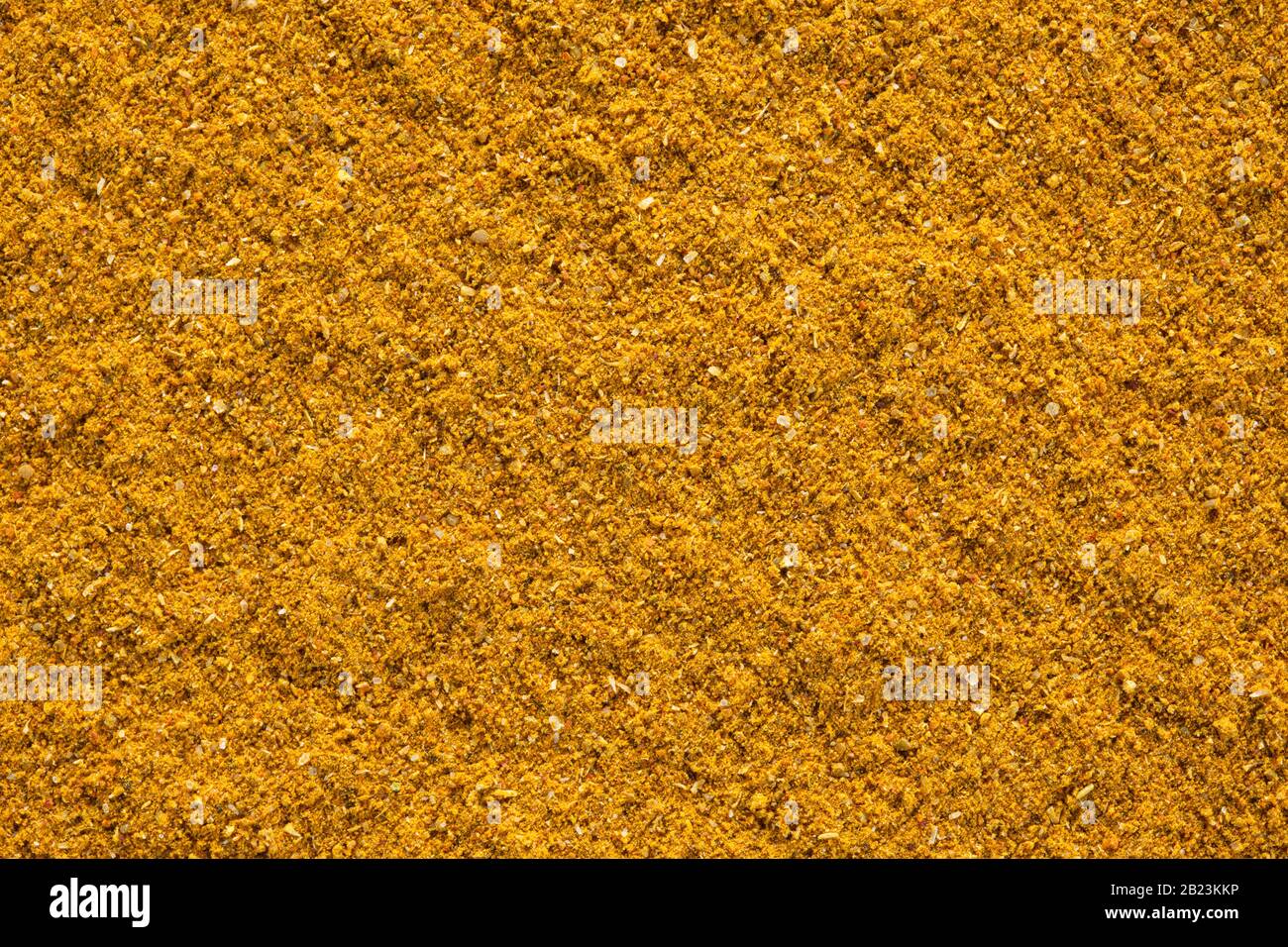 Ground Curry (Madras Curry)-Textur, Hintergrund mit vollem Rahmen. Wird weltweit als Gewürz in der Küche verwendet. Stockfoto
