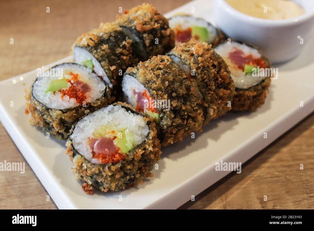 Heiße gebratene Sushi-Rolle mit Thunfisch, Avocado und Käse. Sushi-Menü. Japanische Küche. Stockfoto
