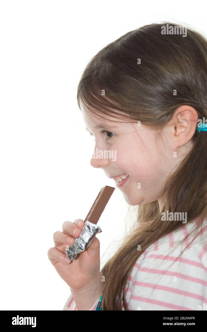 Fröhliche 6-Jährige, die einen Schokoladenkeks essen will Stockfoto
