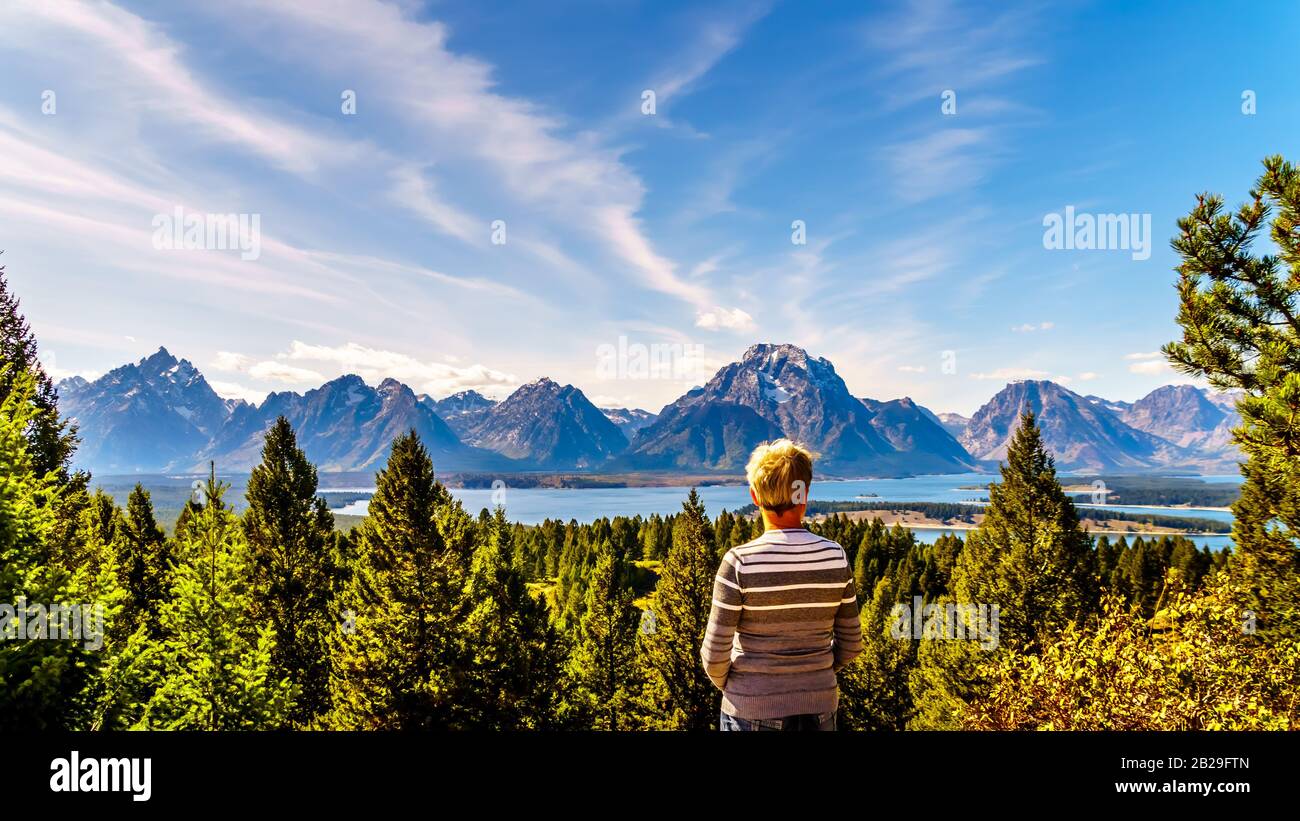 Frau, die vom Signal Mountain im Grand Teton National Park in Wyoming den Blick auf den Jackson Lake und die Berggipfel der Teton Range genießt Stockfoto