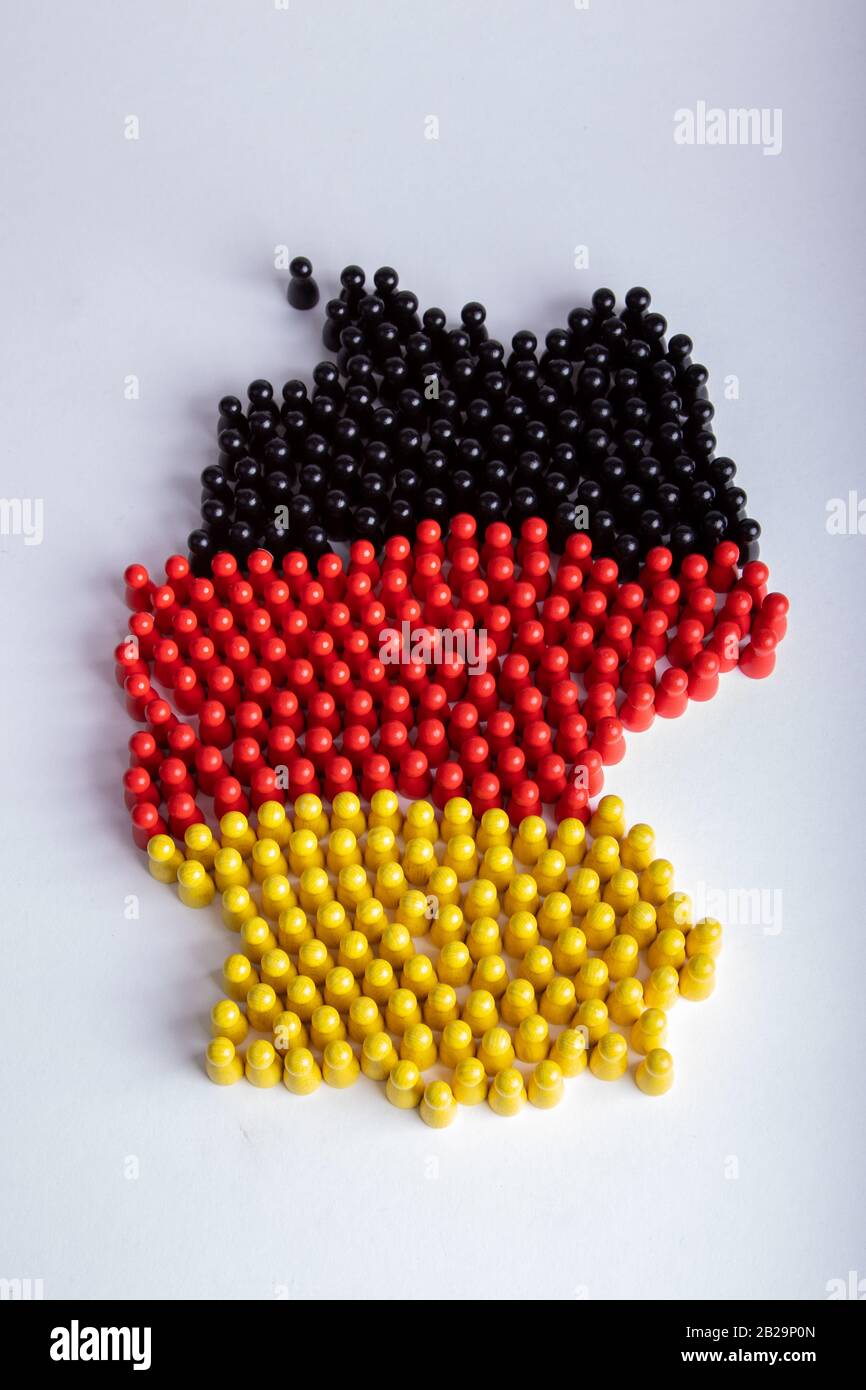 Karte von Deutschland, in Nationalflaggenfarben, mit Holzfigürchen, weißem Hintergrund, isoliert auf Weiß Stockfoto