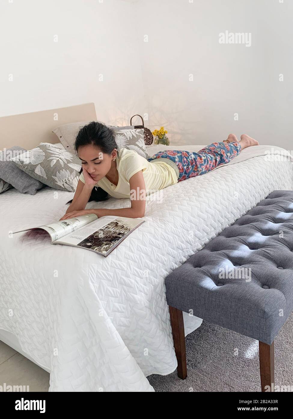 Hispanische Frau, die sich im Bett erholt und eine Zeitschrift liest, Panama, Mittelamerika Stockfoto