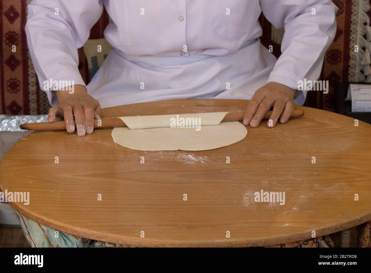 Frau rollt Teig aus, Nahaufnahme. Traditionelle türkische Flat Cakes. Stockfoto