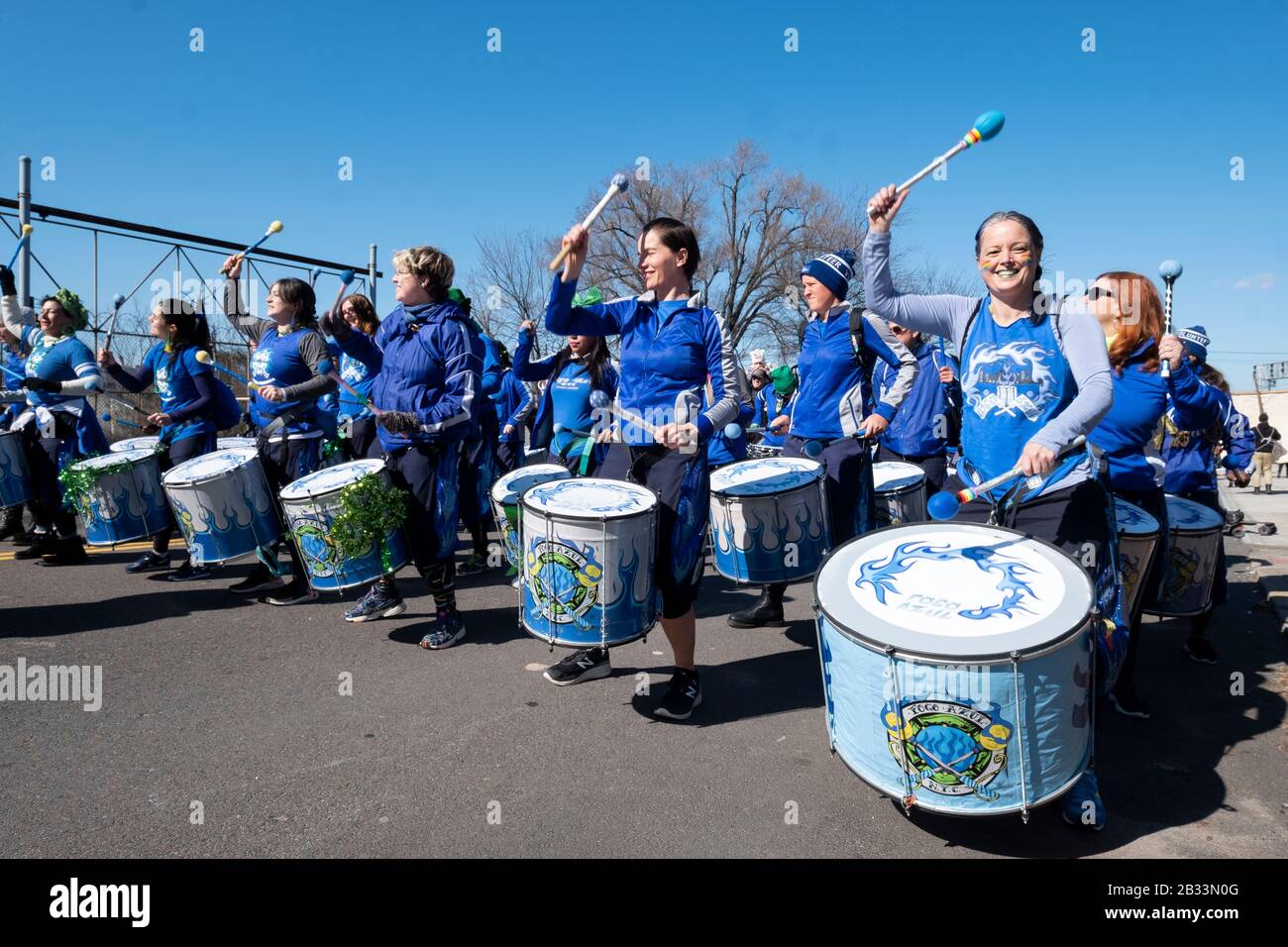 Mitglieder der Fogo Azul All-female Drumline Marching Band wärmen sich auf, bevor sie in der St. Patrick's Day Parade für Alle in Sunnyside, Queens, New marschieren Stockfoto