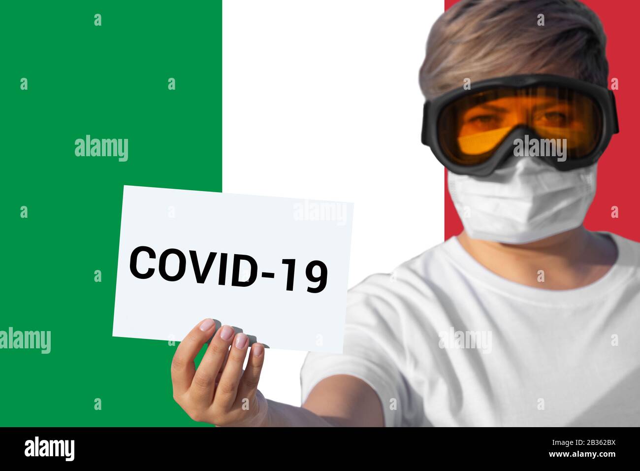 Frau in Gesichtsmaske hält Bogen mit Aufschrift COVID-19 gegen italienische Flagge. Konzept der Aufmerksamkeit über die Verbreitung des chinesischen Coronavirus COVID-19 Roman Coronavirus Pneumonie Virus auf der ganzen Welt Stockfoto