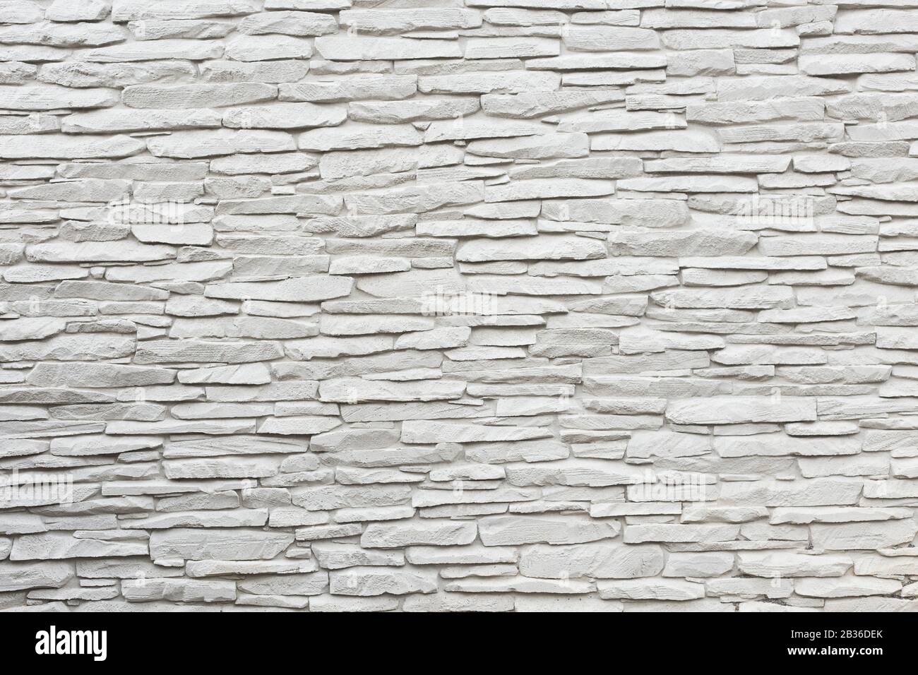 Eine Weiße Wand aus Grautönen aus Stein für den Einsatz als Hintergrund. Stockfoto