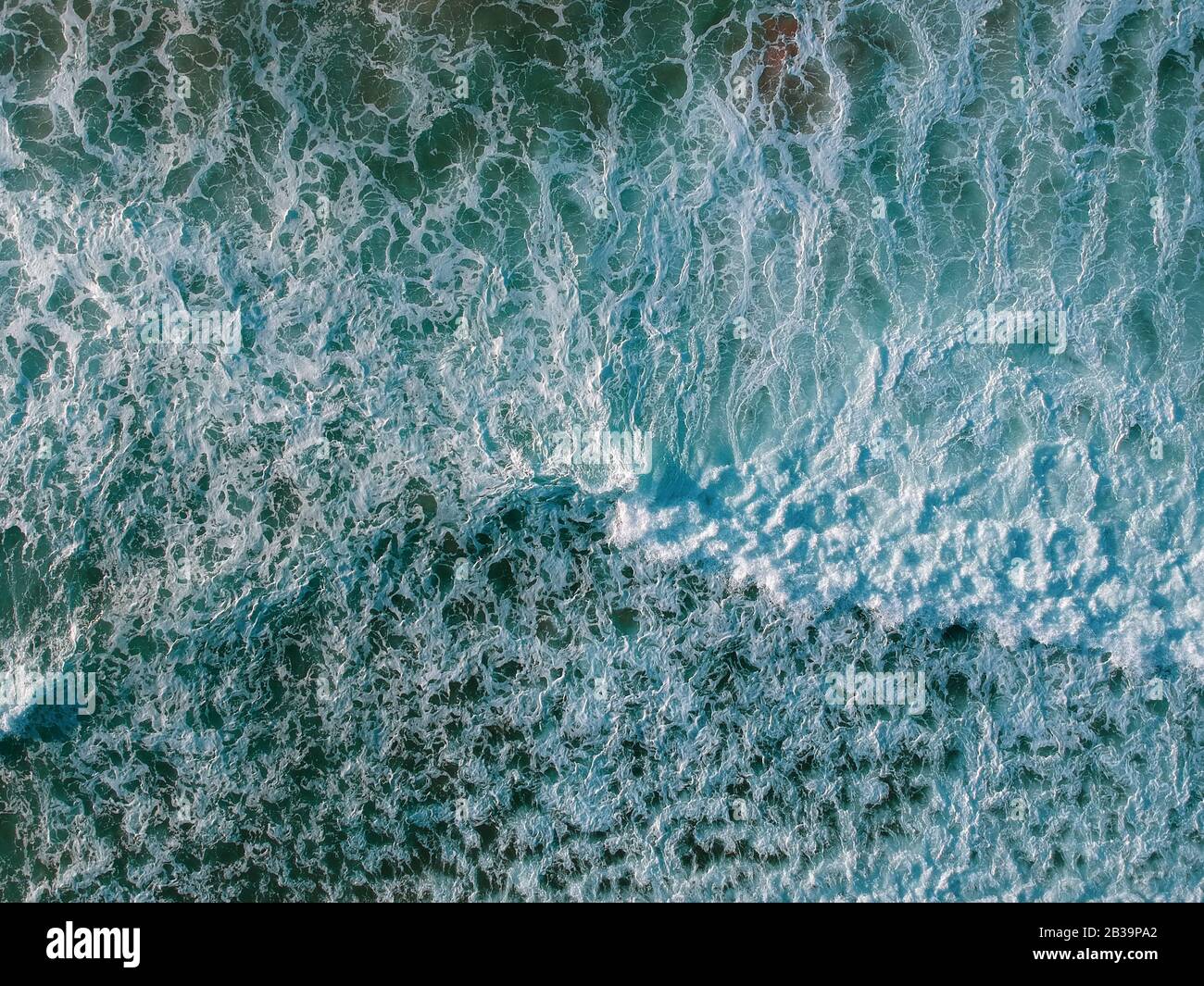 Luftaufnahme von einer großen Welle, die in einem Strand zusammenbricht. Drohnenansicht Stockfoto