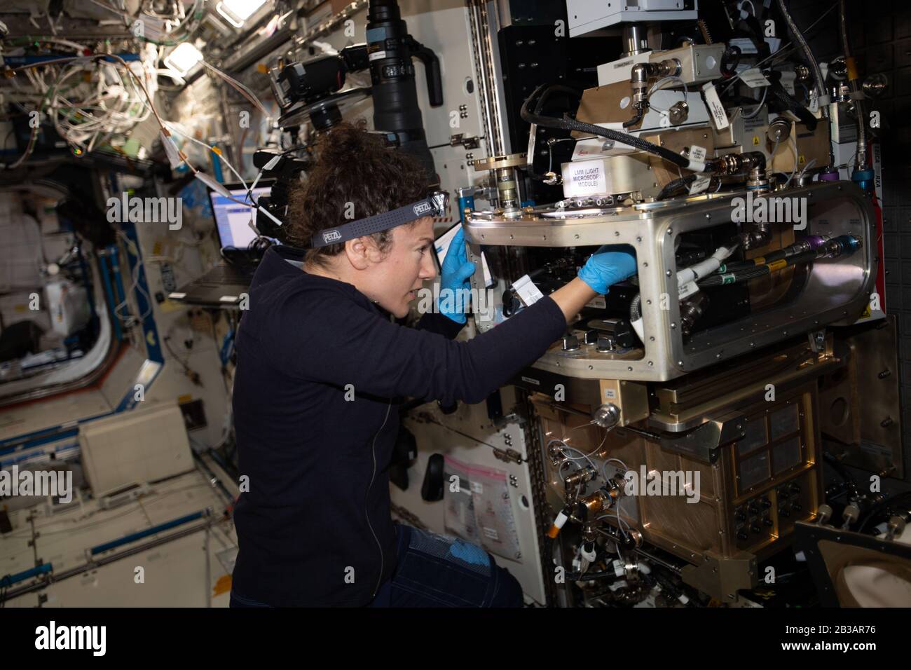 ISS - 16. Februar 2020 - NASA Astronautin und Expedition 62 Flugingenieurin Jessica Meir konfiguriert das Lichtmikroskopie-Modul innerhalb der Fluids Integrated Stockfoto