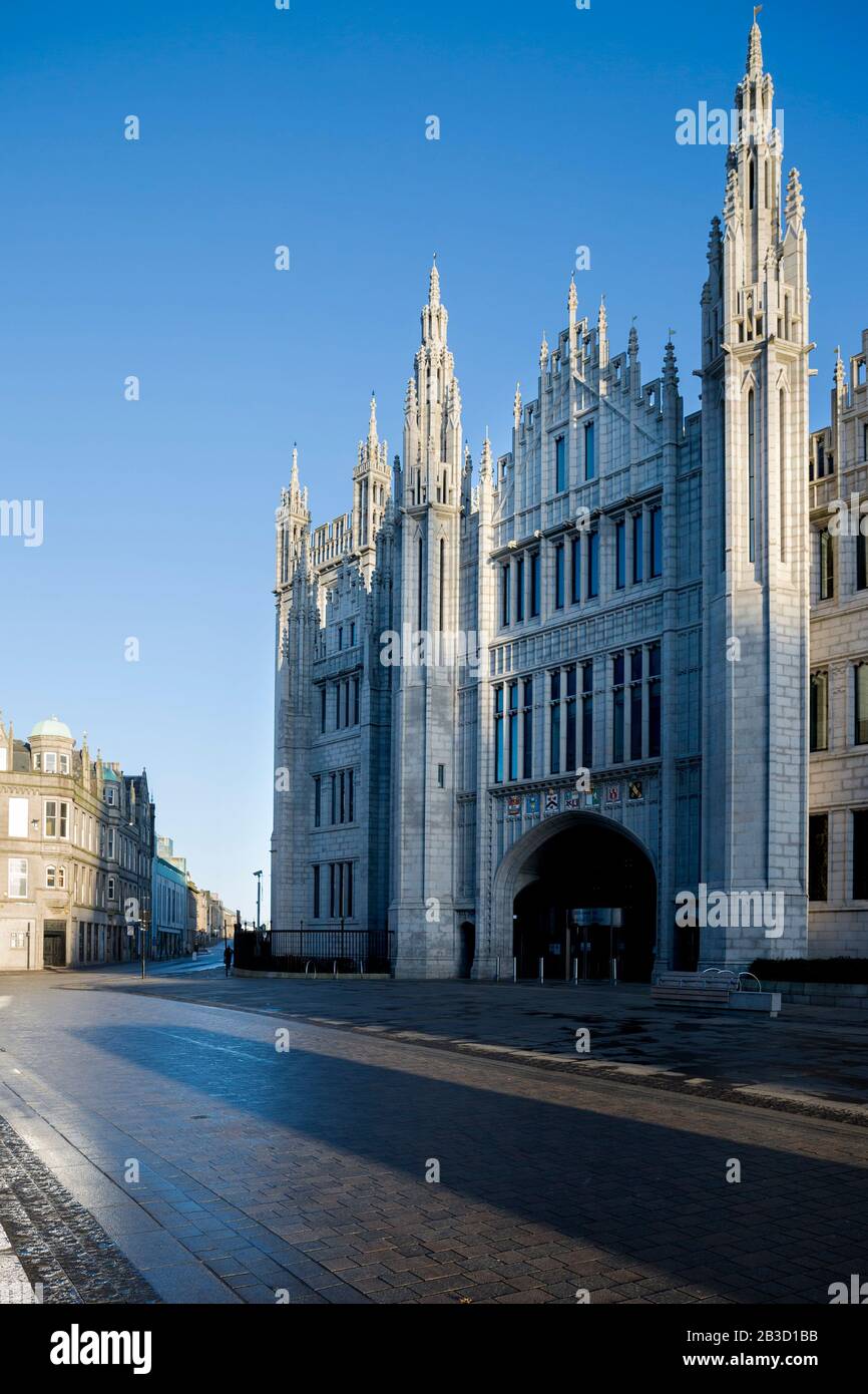 Die Fassade des Marischal College in Aberdeen, Schottland, badete im Morgenlicht mit blauem Himmel. Von Der Broad Street aus gesehen Stockfoto